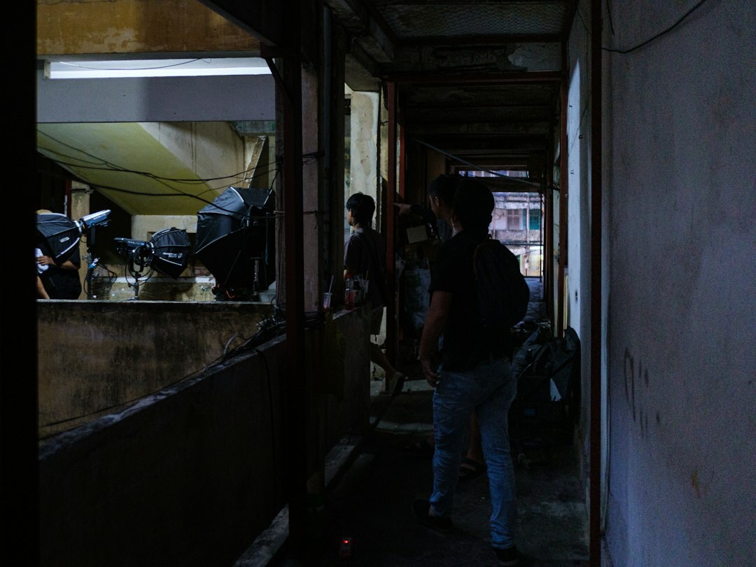 Broadcast crew walking together through a media facility corridor